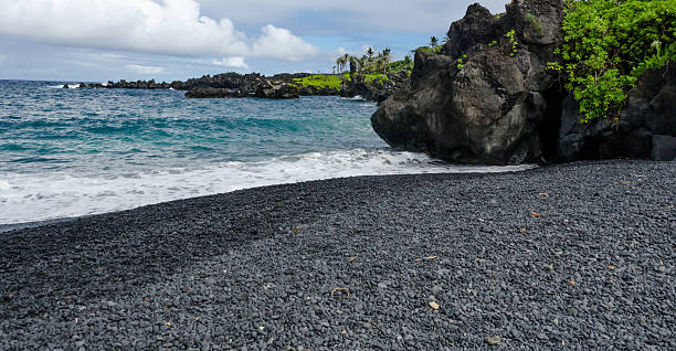 Maui Maui coastline with blue skies and lava rocks hana coast stock pictures, royalty-free photos & images