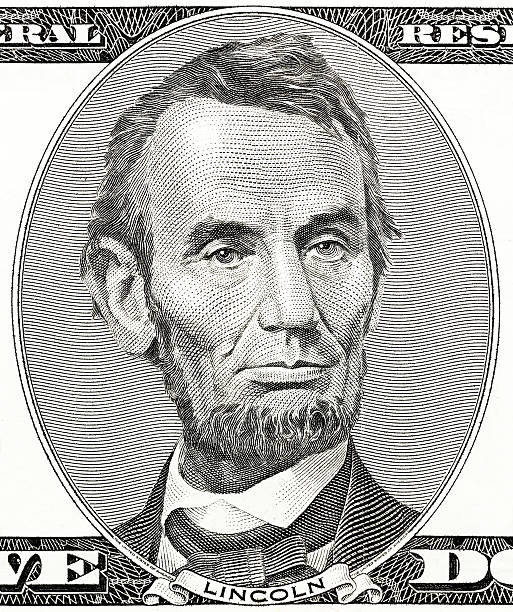 istock president Abraham Lincoln as he looks on five dollar bill 175730583