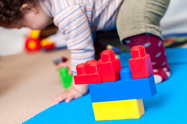 istock Baby Girl Playing With Plastic Building Blocks 175731319