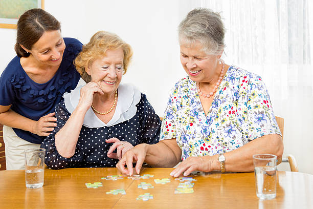 istock Senior women couple assembling a jigsaw puzzle 175731322
