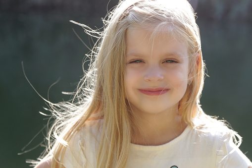 Happy laughing girl on grass. Smiling one child outdoors