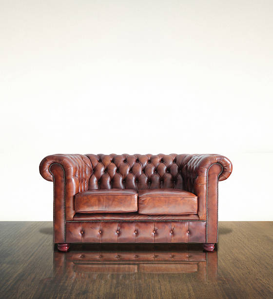 istock Classic Brown leather sofa and old wood background. 175733878