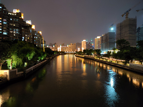 Modern residential buildings along the Suzhou Creek in Putuo district by night, Shanghai, China