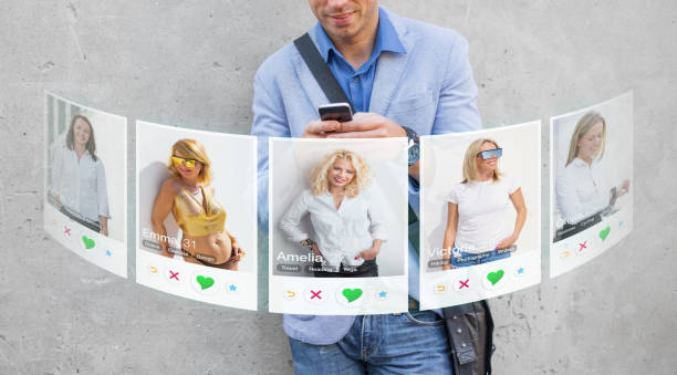 Concept of online dating. Man viewing different girls profile photos in dating app on mobile phone. stock photo