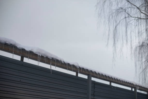 istock Roof in snow. Icicles on visor. Temporary construction. 1757370602