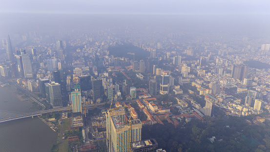 Aerial view of Ho Chi Minh city skyline with buildings, roads, bridge and Saigon river in Vietnam in the morning. Travel and business concept.