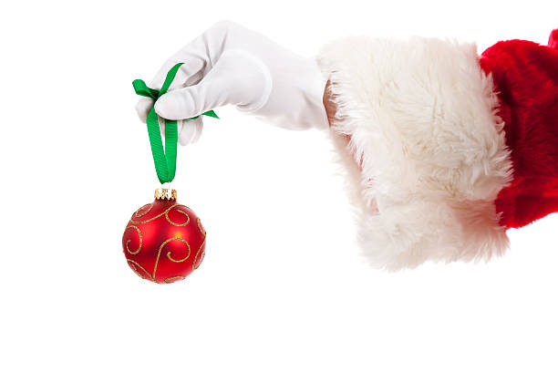 istock Santa's hand holding a red Christmas ornament 175739847