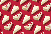 Piece slice cheesecake pattern on red background isolated