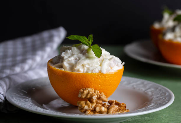 istock Celery salad with apple and walnuts served in orange cups. 1757417212