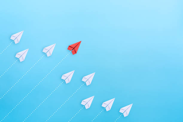 istock Leadership concept with red paper plane leading among white on blue background with copy space 1757419385