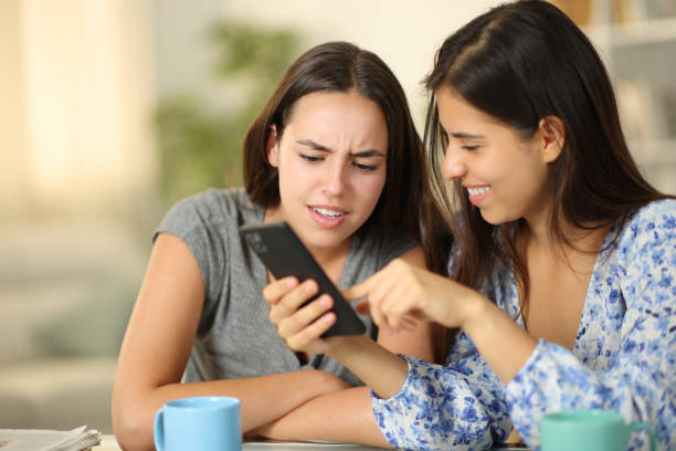 istock Two friends watching funny media content on phone 1757419396