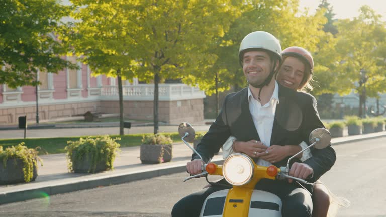 Man and woman enjoy ride on motorcycle through city streets