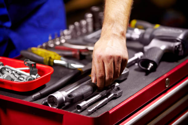 Finding the perfect tool Cropped image of a man's hands grabbing a tool from his toolbox open end spanner stock pictures, royalty-free photos & images