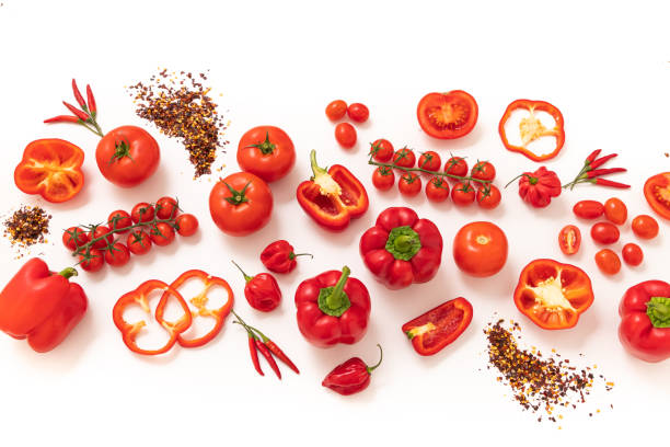 Group of red vegetables arranged on a banner shape on white background