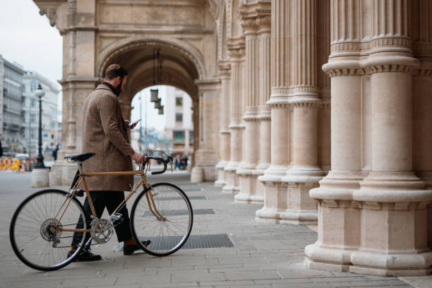 istock Young man holding smartphone and walking with bicycle. Eco friendly transport. 1757446002