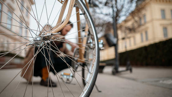 Man checking wheels on bike. Reparing bicycle. High quality photo