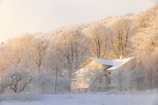 Falköping, Sweden-December, 2022: Idyllic old house by the forest a cold frosty winter day