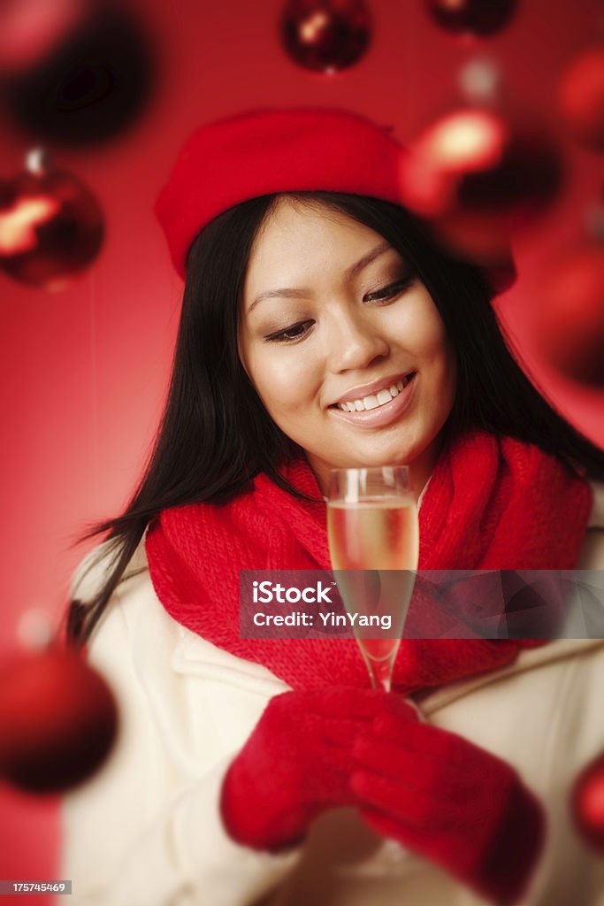 Young Asian Woman Model Holding Champagne in Christmas Background Subject: A happy young woman celebrating Christmas with a glass of chilled champagne. 20-29 Years Stock Photo