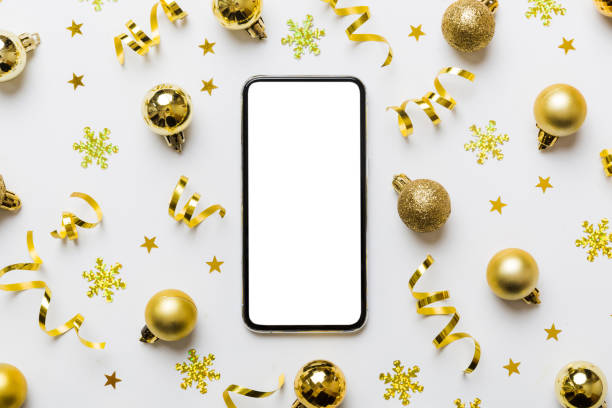 istock Christmas online shopping from home phone with blank white display top view. smart mobile with copy space on colored background with Christmas decorations balls,. Winter holidays sales background 1757455172
