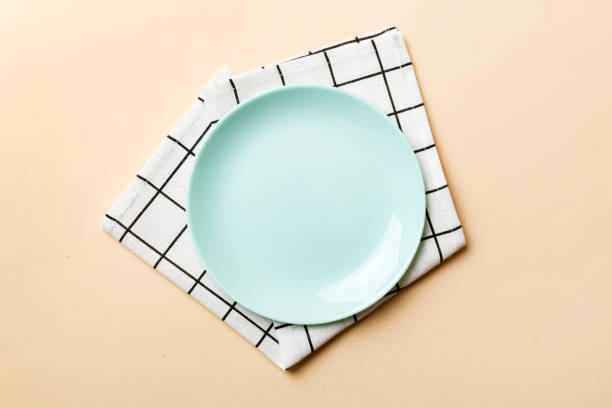 istock Top view on colored background empty round blue plate on tablecloth for food. Empty dish on napkin with space for your design 1757455330