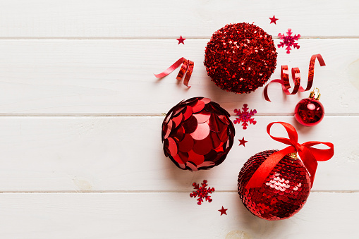 Christmas ball on colored background. decoration bauble with ribbon bow with copy space.