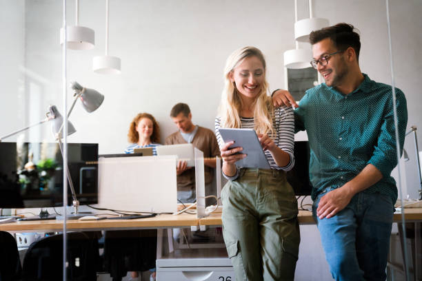 istock Two young businesspeople using a digital tablet while standing in a boardroom. 1757462115