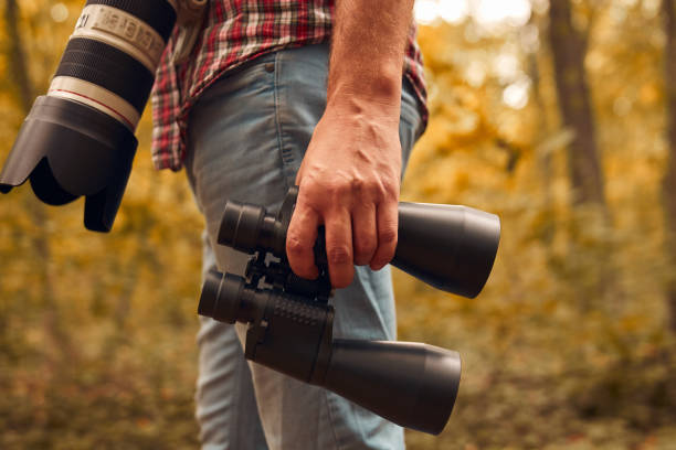 istock Man using binoculars and camera for birdwatching and other observing animals in nature. 1757462643