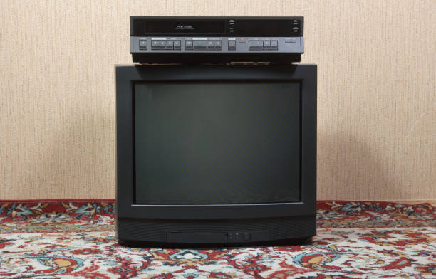 istock Old TV with VCR against wallpaper background. 1757464230