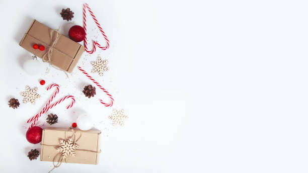 istock Christmas season border frame with candy canes and pine cones, gift box on white background. Creative New Year or Merry Xmas holiday composition. Winter greeting card. 1757474458