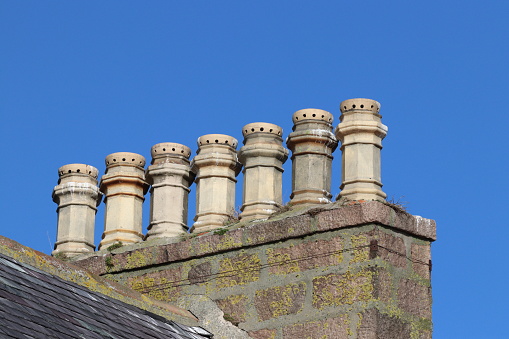 Old chimneys against blue sky