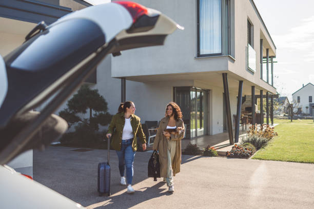 istock Two friends packing and loading luggage into car trunk for their vacation. 1757478910