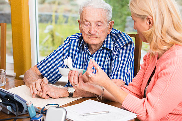 Social worker teaching senior man how to use medical equipment Social worker teaching senior man how to use medical equipment. You might also be interested in these: medical oxygen stock pictures, royalty-free photos & images