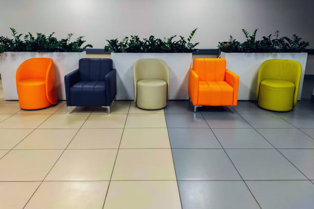 istock Chairs, tables and sofas in the corridor for visitors who will be waiting for their turn to enter the rented premises for various tasks and commercial services 1757488174