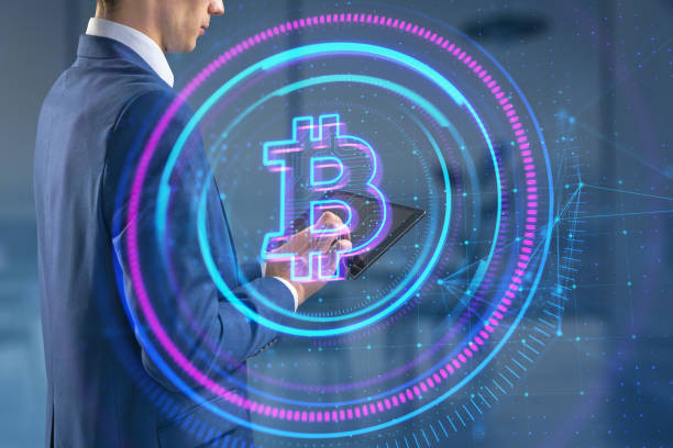 istock Headless white businessman using tablet with glowing round polygonal bitcoin hologram on blurry office background. Online banking and cryptocurrency concept. Double exposure. 1757491870