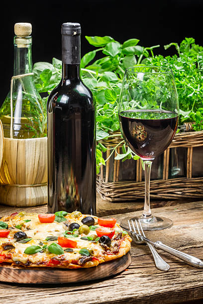 istock Freshly baked pizza served with red wine 175750935