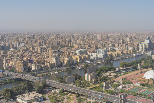 Cairo,Egypt-november,2022: urban view of bustling traffic and crowded buildings. Cairo is the capital of Egypt, the economic center of the country and one of the most populated and polluted cities in the world.