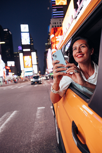 Yellow taxi billboard with clipping path. Crowded with commercial signs, there is intense competition for attention in Times Square, New York City.