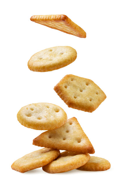 istock Cookie crackers fall on a pile close-up on a white. Isolated 1757516284
