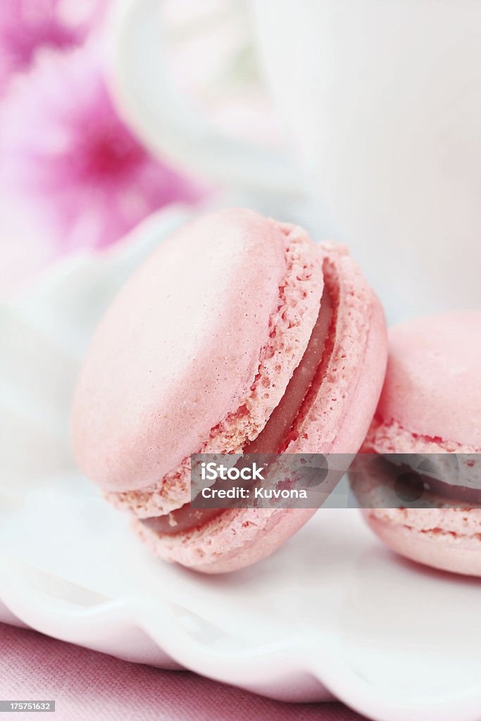 Pink macaroons Closeup of delicious pink French macarons almond cookies served with a cup of coffee Tray Stock Photo