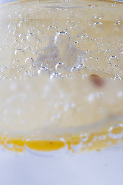 Bubbles Close up photo of a sparkling water bubbles in a glass with a slice of a lemon soda water glass lemon stock pictures, royalty-free photos & images