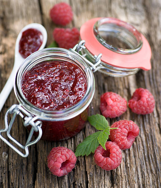 Raspberry jam Raspberry jam in a preserving glass raspberry jam stock pictures, royalty-free photos & images