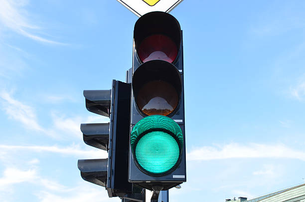 istock Green color traffic light blue sky in background 175752346