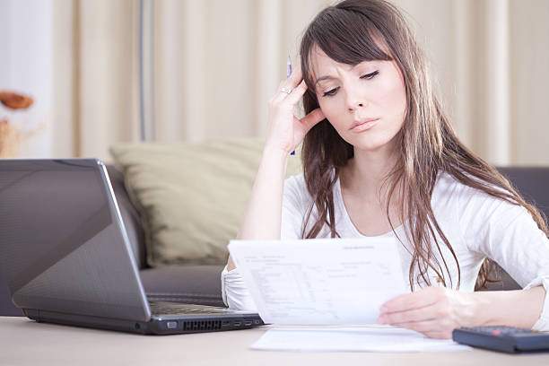 istock Concerned young woman looking at bills. 175752630