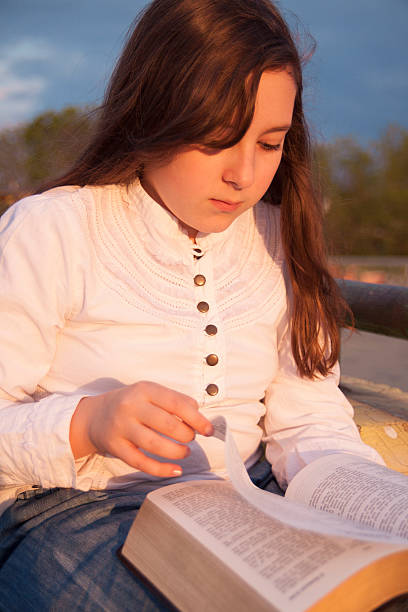 istock Beautiful girl reading holy bible 175752847