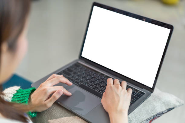 istock Woman working with modern laptop computer blank white desktop screen for advertising, mockup, technology, advertising, search information, creative design on table 1757535840