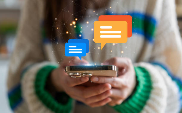 istock Human hand using smartphone typing Live chat chatting and social network concepts, chatting conversation working at home in chat box icons pop up. Social media marketing technology concept 1757536400
