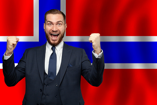 Norwegian happy businessman on the background of flag of Norway Business, education, degree and citizenship concept