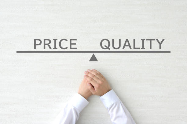 istock Business man's hands and scale with PRICE and QUALITY word 1757543587
