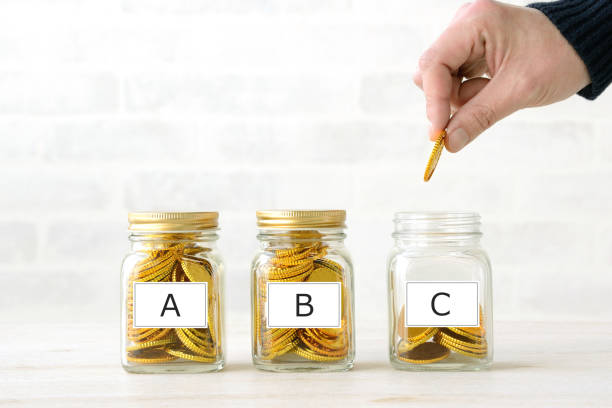 istock Human's hand saving money into bottles with alphabet word tags 1757544130