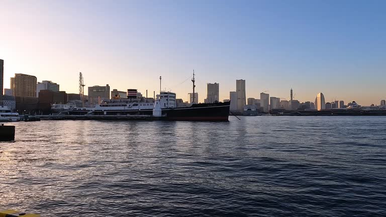 Beautiful calm evening light above the skyline and waterfront of Yokohama minato mirai. Blue sky and water skyscrapers and Soft reflection in the water
